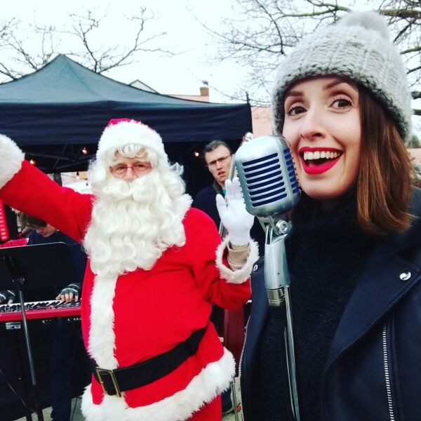 vocalist singing at xmas concert in toronto with santa claus